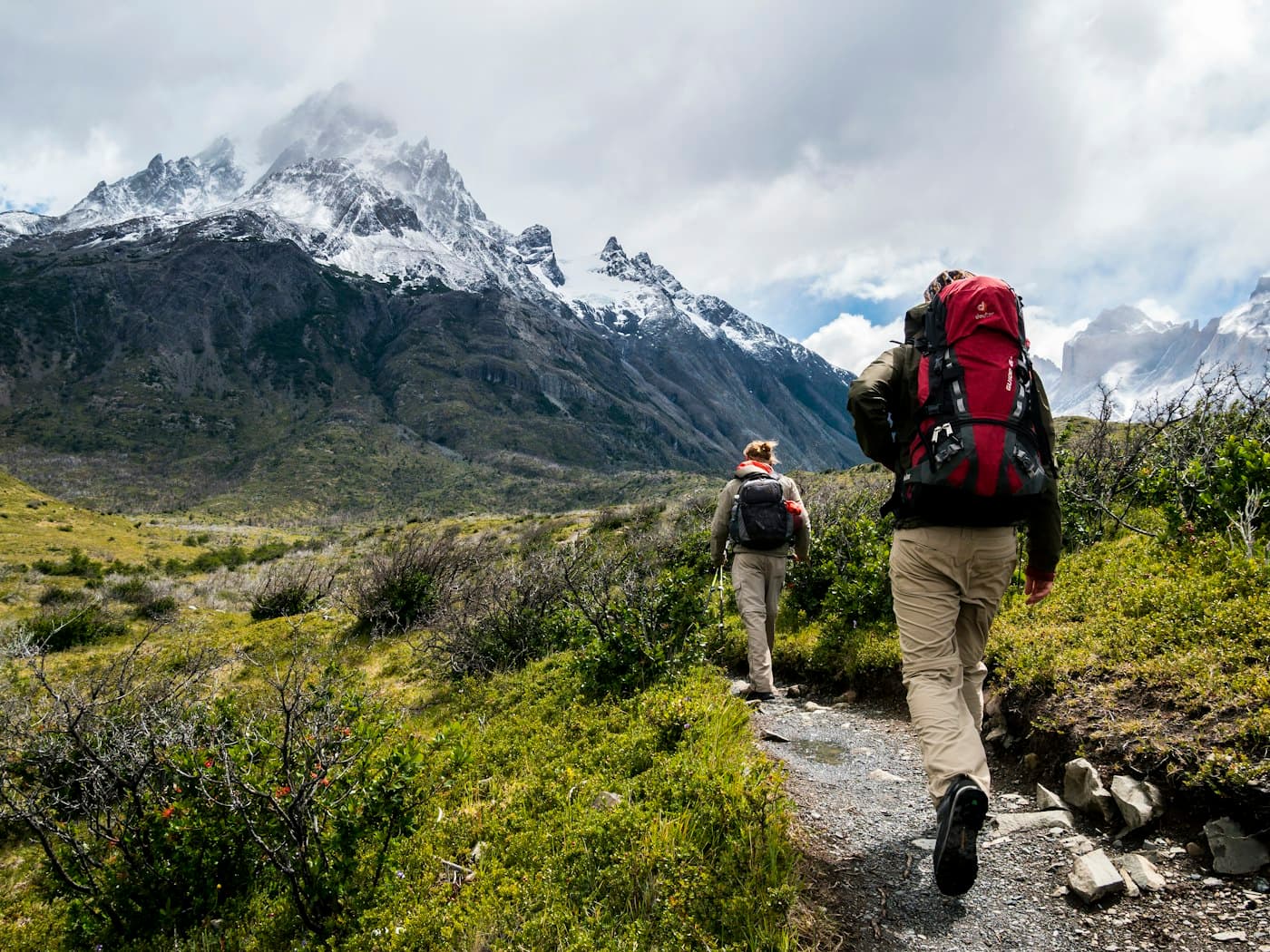 Two hikers with backpacks on a mountain trail