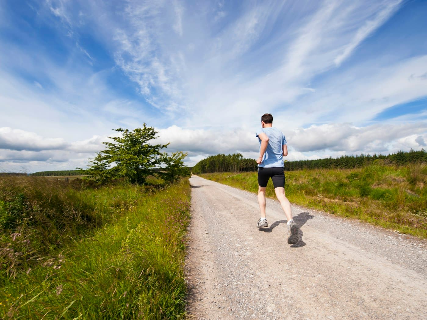 A person running along a country road